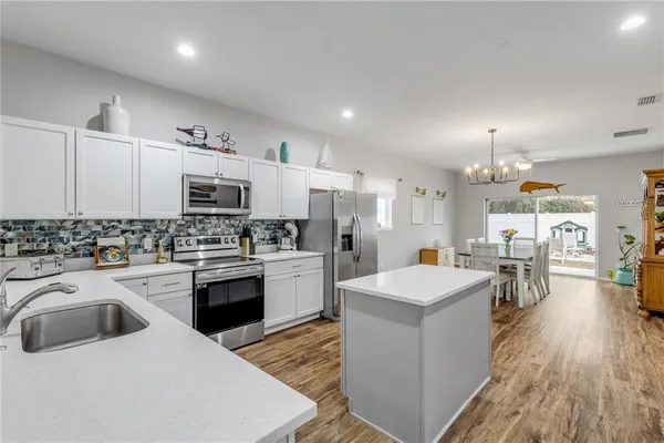 a kitchen with a sink stove and microwave