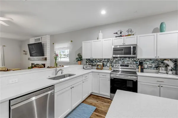 a kitchen with a sink stove and cabinets