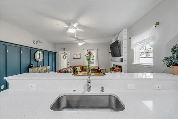 a view of a dining room with furniture a chandelier and wooden floor