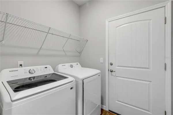 a spacious bedroom with a bed wooden floor and window