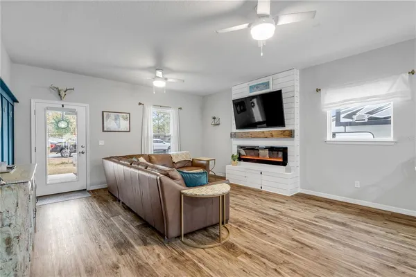 a living room with furniture a flat screen tv and a fireplace
