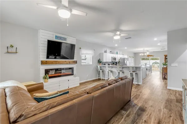 a living room with furniture and kitchen view