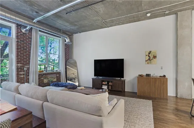 a living room with furniture and a flat screen tv