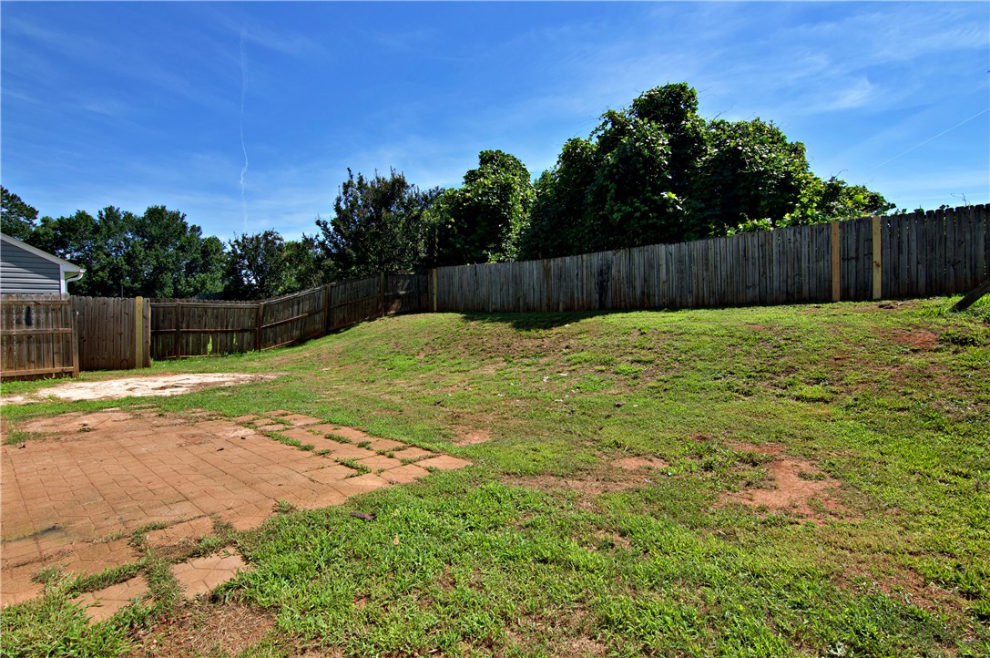 305 North Chestnut Street Seneca, SC 29678 - Photo 40 of 44 A spacious backyard awaits, complete with a brick patio and privacy fencing.