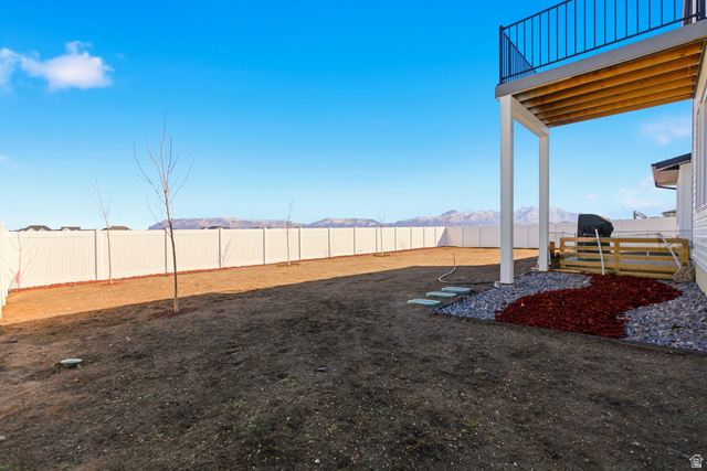 3902 West 825 North West Point, UT 84015 - Photo 32 of 49 Fenced backyard featuring a mountain view and a balcony