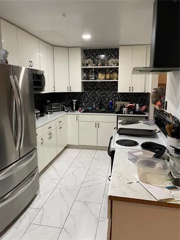 a kitchen with granite countertop a sink stainless steel appliances and cabinets