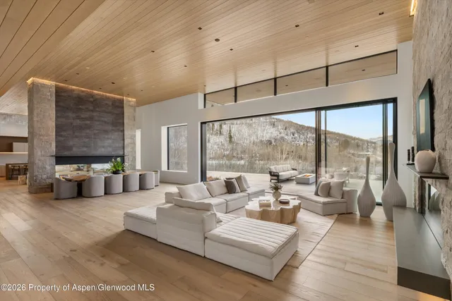 a living room with furniture and large windows