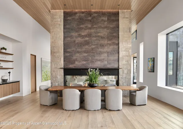 a bedroom with a large window and a glass door