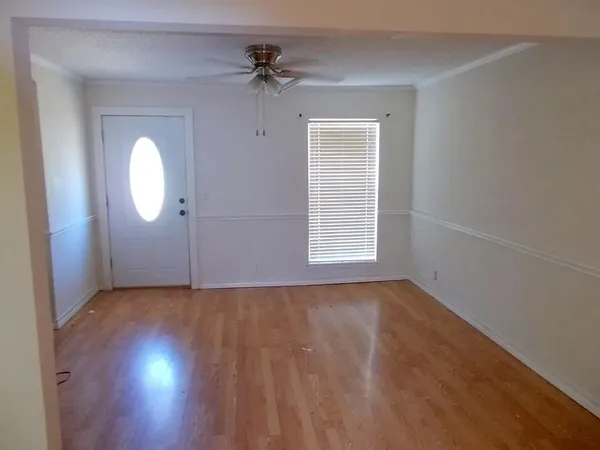 wooden floor in an empty room with a window