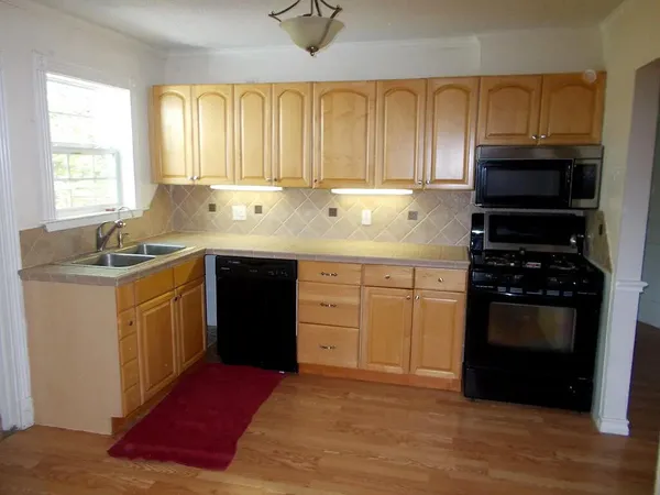 a kitchen with a sink stove and cabinets
