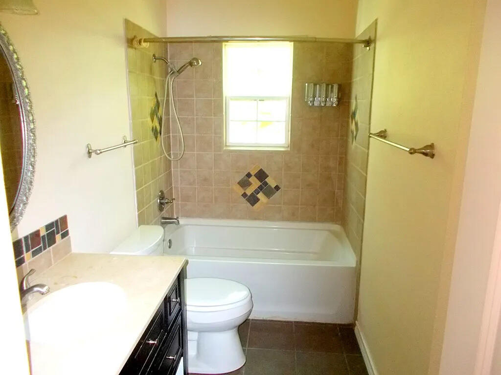 1409 East 11th Place Big Spring, TX 79720 - Photo 10 of 12 a bathroom with a sink a toilet and a bathtub