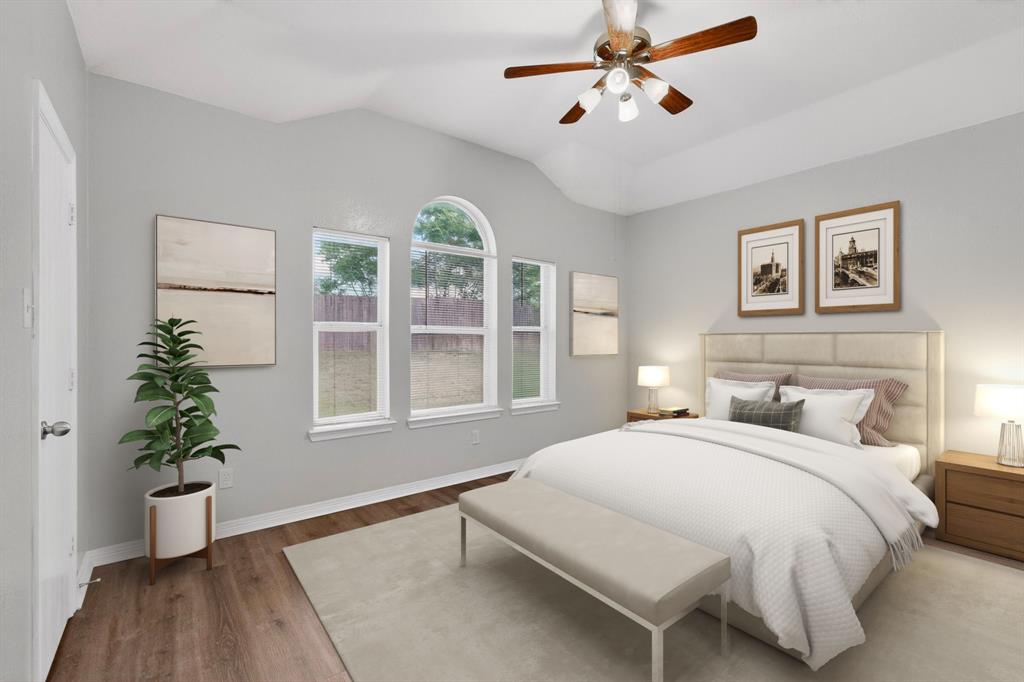 3401 Newgate Street Midlothian, TX 76065 - Photo 20 of 34 Spacious bedroom featuring a vaulted ceiling with a ceiling fan, three windows including an arched window, and wood-finish flooring
