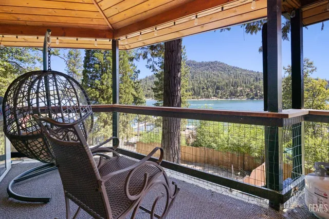 a kitchen with stainless steel appliances kitchen island granite countertop a stove refrigerator and cabinets