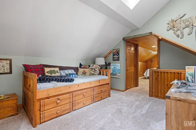 a view of a balcony with table and chairs potted plants with wooden floor and fence