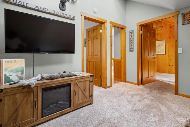 a view of a patio with wooden floor table and chairs