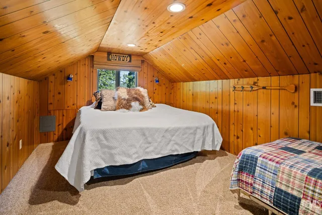 a bedroom with a large bed and a large window