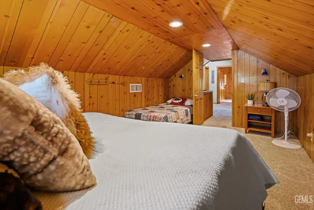 a large bed sitting in a bedroom next to a window