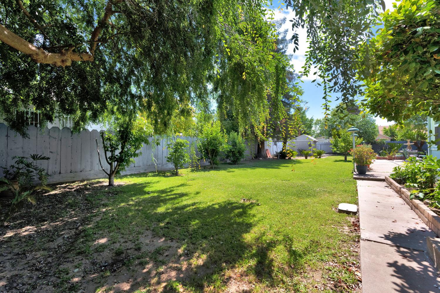 200 Lyons Street Madera, CA 93638 - Photo 27 of 32 a green field with lots of trees in it