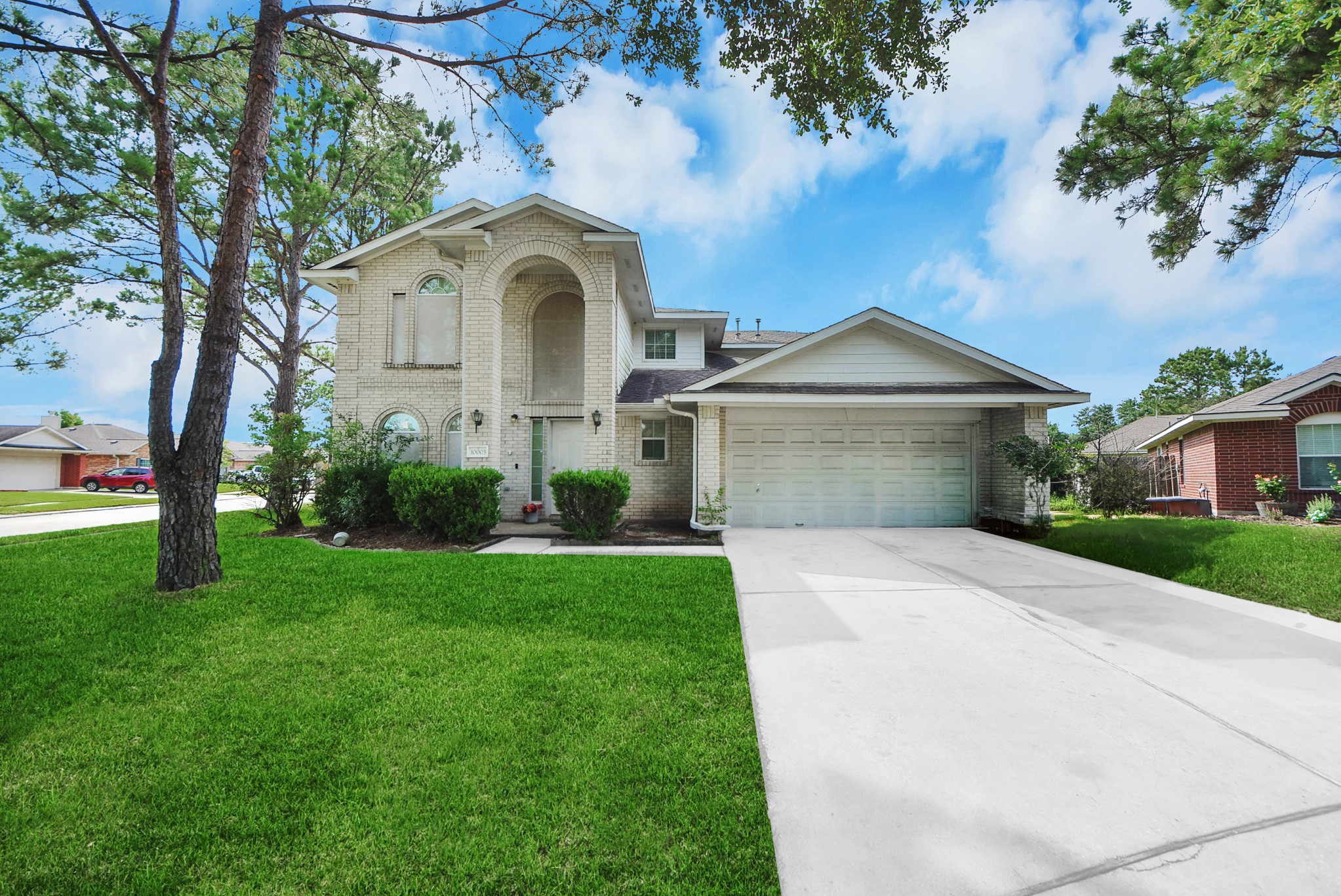 10003 Dakota Ridge Court Houston, TX 77095 - Photo 1 of 30 a front view of a house with garden