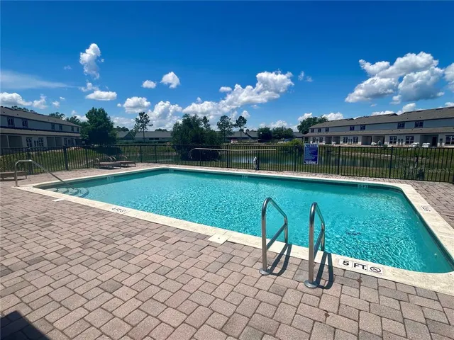an aerial view of a house with a swimming pool yard and outdoor seating