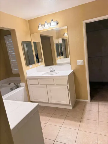 a bathroom with a sink a vanity and a mirror