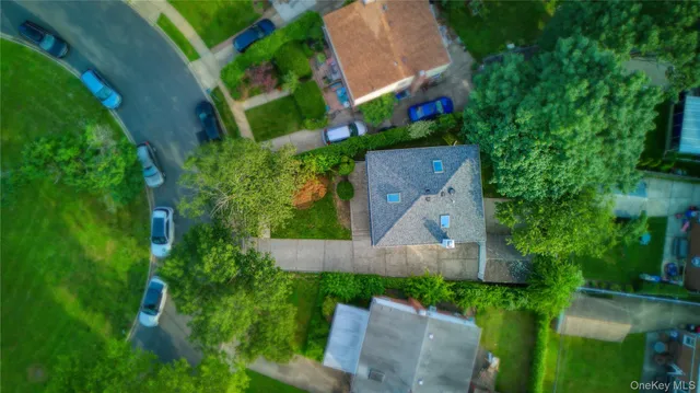 an aerial view of a house with a yard and lake view