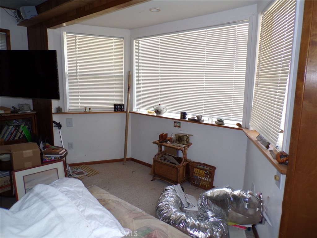 4880 Bonanza Road Johnson Valley, CA 92285 - Photo 8 of 19 a room with furniture and a flat screen tv