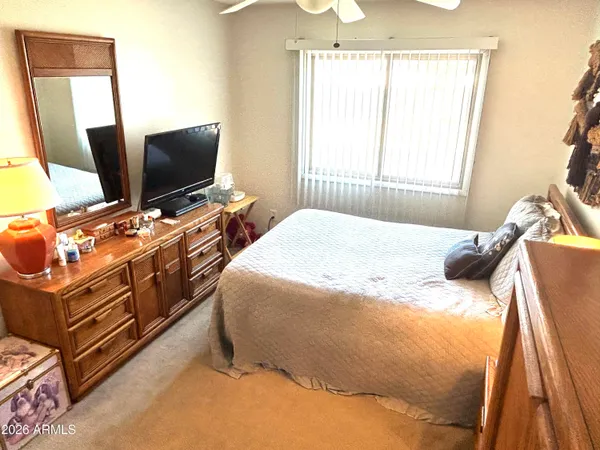 a bedroom with a bed and a mirror