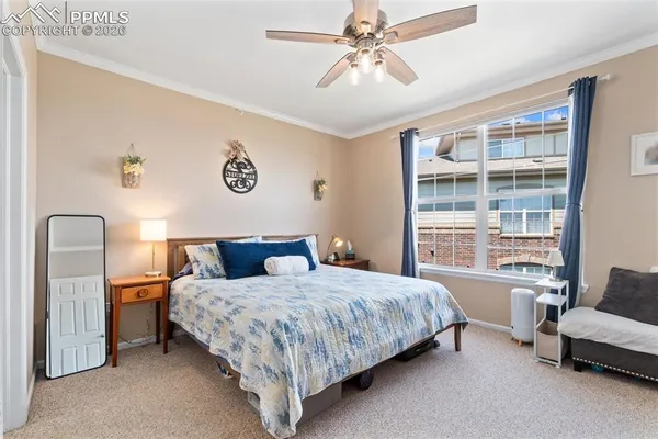 a bedroom with a bed a couch and a window