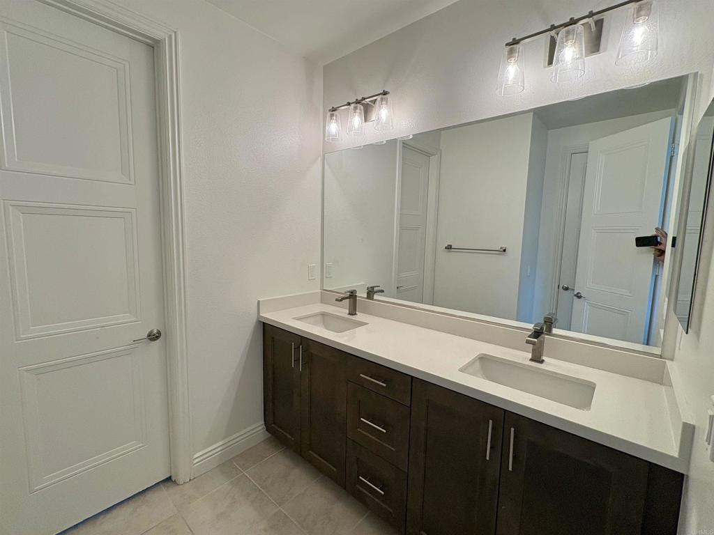 39529 Dayspring Way Temecula, CA 92591 - Photo 34 of 49 a bathroom with a double vanity sink and a mirror