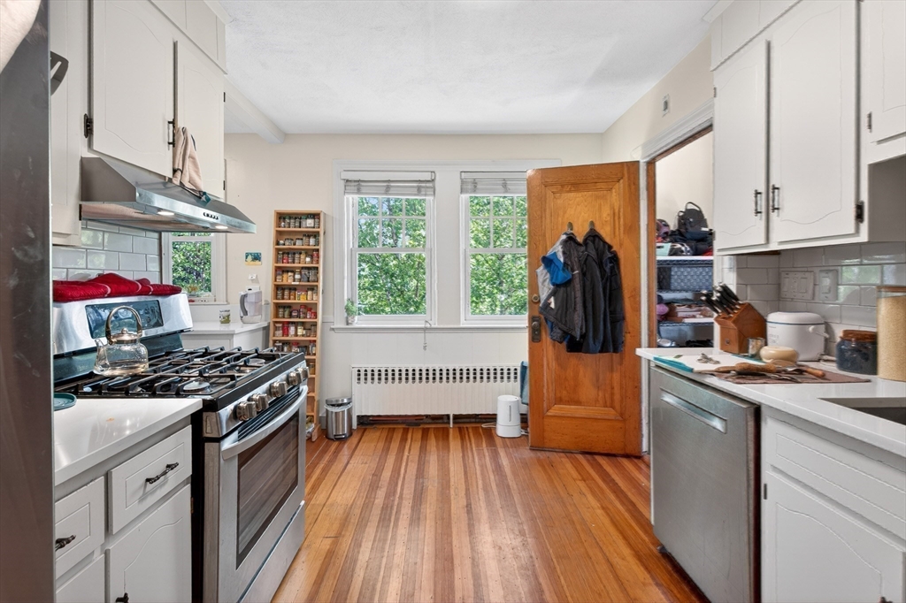 76-78 Lewis Road Belmont, MA 02478 - Photo 24 of 36 a kitchen with stainless steel appliances a stove a sink and a refrigerator