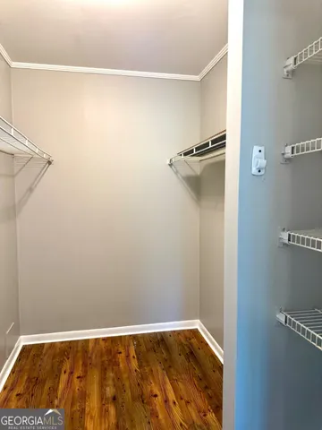 a view of a room with wooden floor
