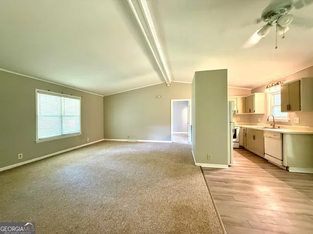 a view of a kitchen with a sink and a window