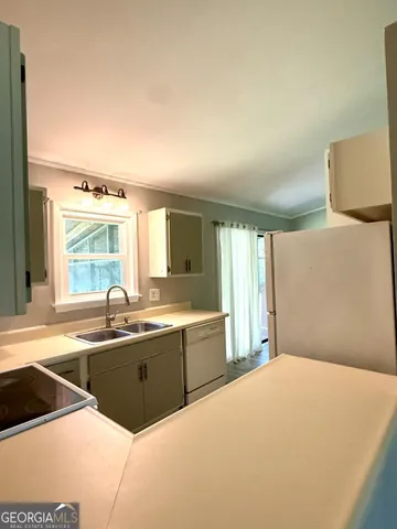 a spacious bathroom with a tub sink and mirror