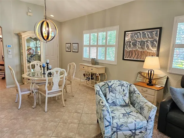 a living room with furniture a window and a mirror
