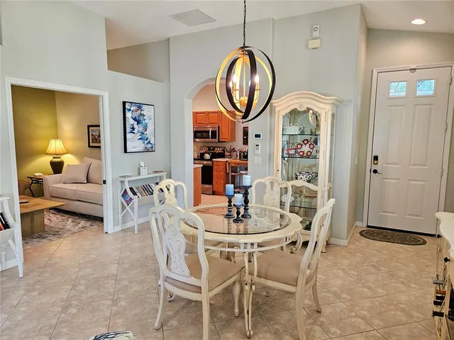 a dining room with furniture a rug and a mirror