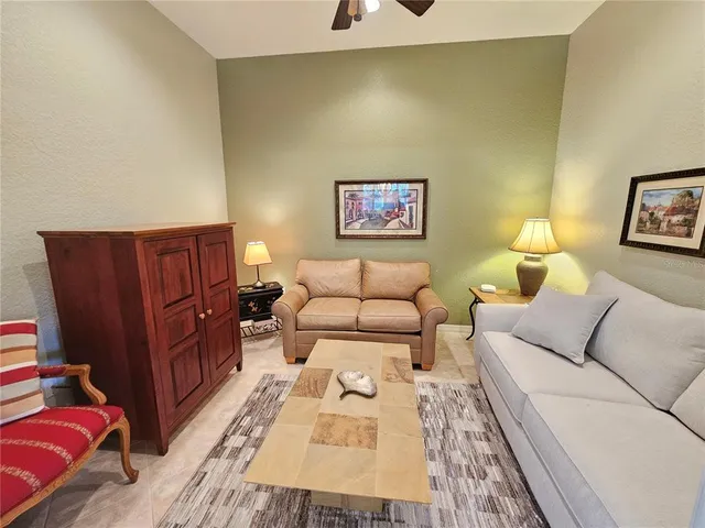 a living room with furniture and baby crib