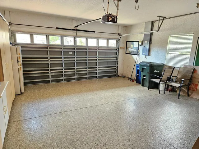 a view of a swimming pool with a table and chairs under an umbrella