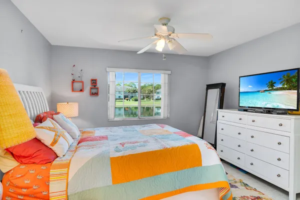 a bedroom with a bed and flat screen tv