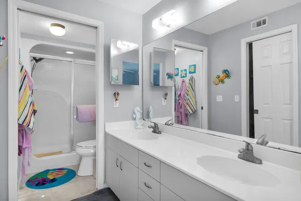 a bathroom with a sink a toilet and shower curtain