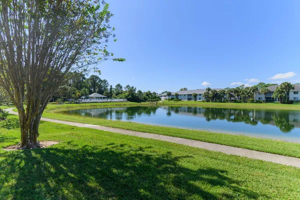 a view of a lake with houses in the background