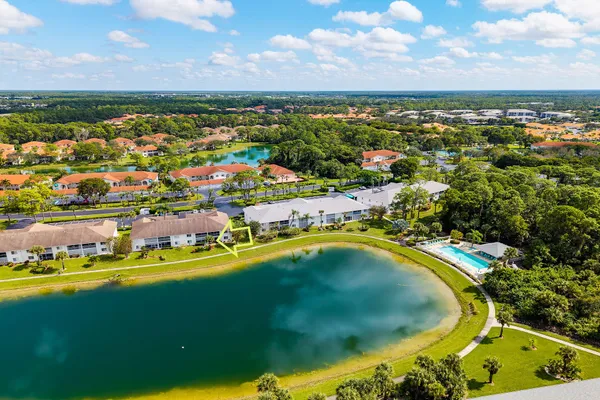 an aerial view of residential houses with outdoor space and swimming pool