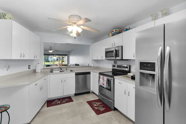 a kitchen with a sink stainless steel appliances and cabinets