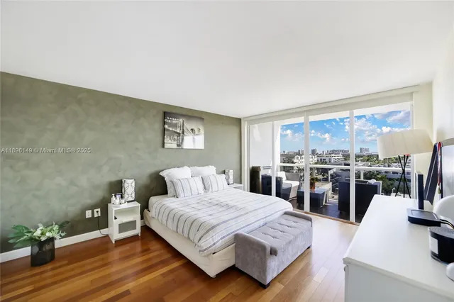 a bedroom with a bed and painting on the wall