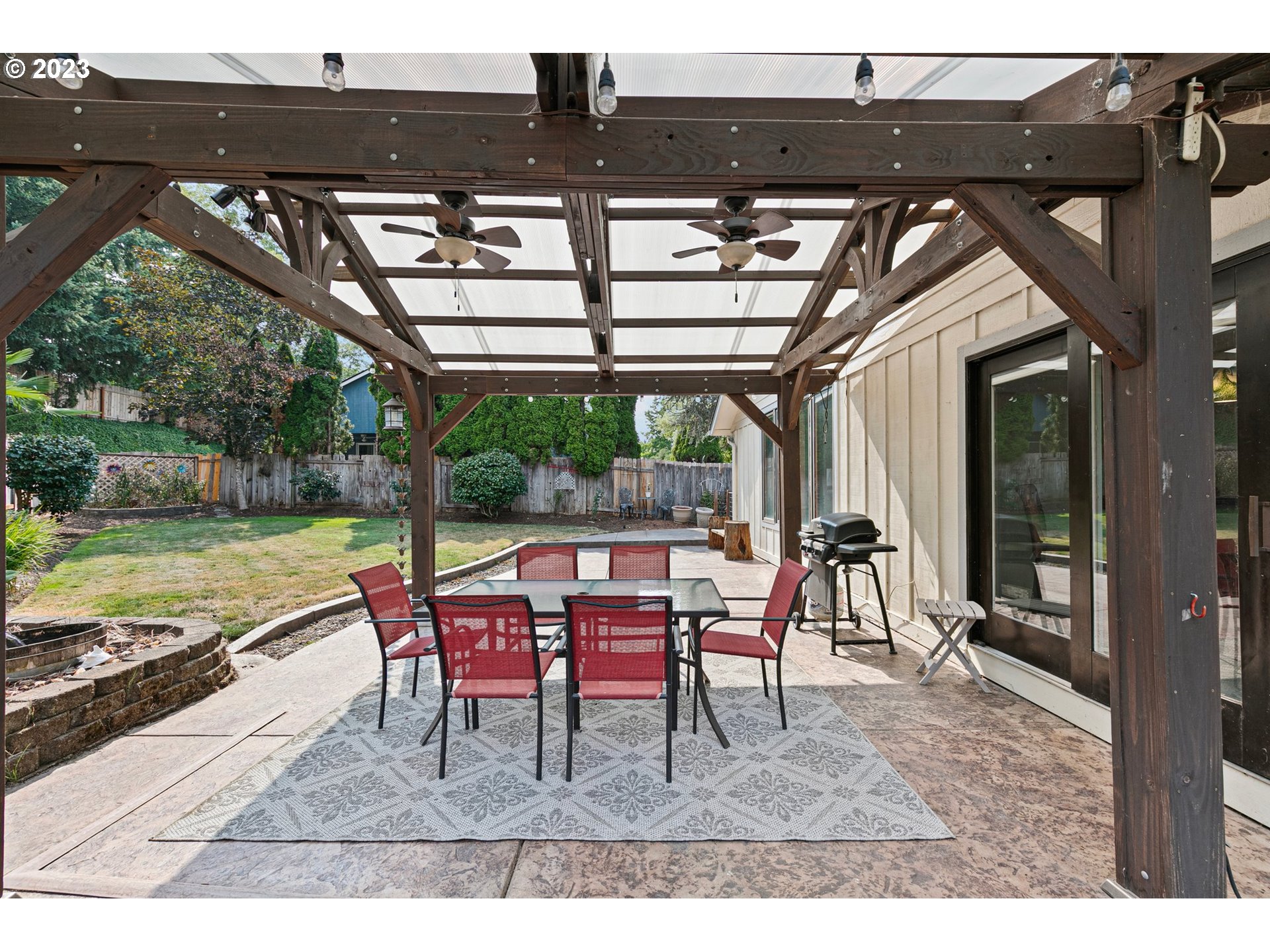 184 73rd Place Springfield, OR 97478 - Photo 41 of 48 a view of a patio with table and chairs next to a yard