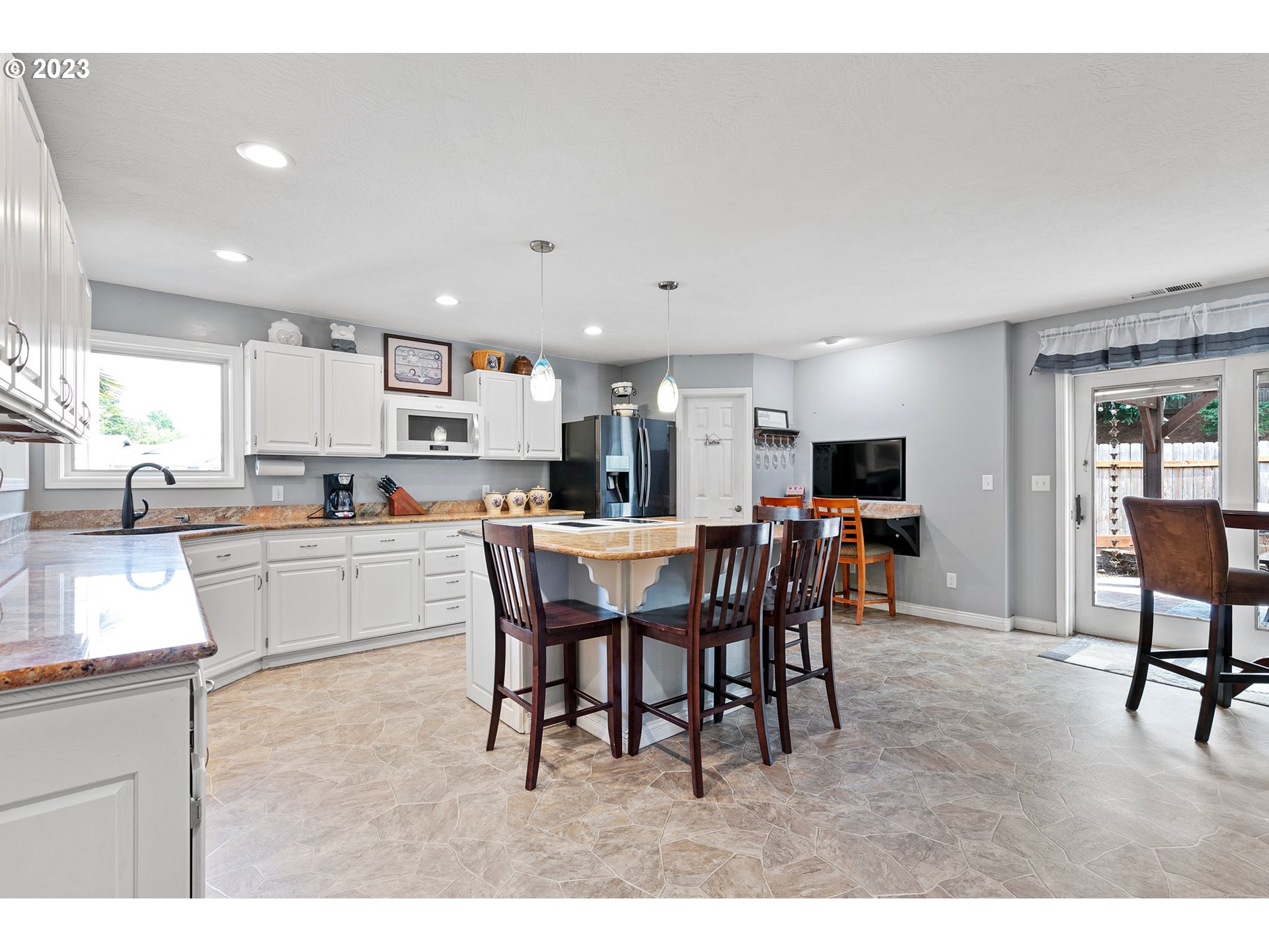 184 73rd Place Springfield, OR 97478 - Photo 6 of 48 a kitchen with a dining table chairs and white appliances