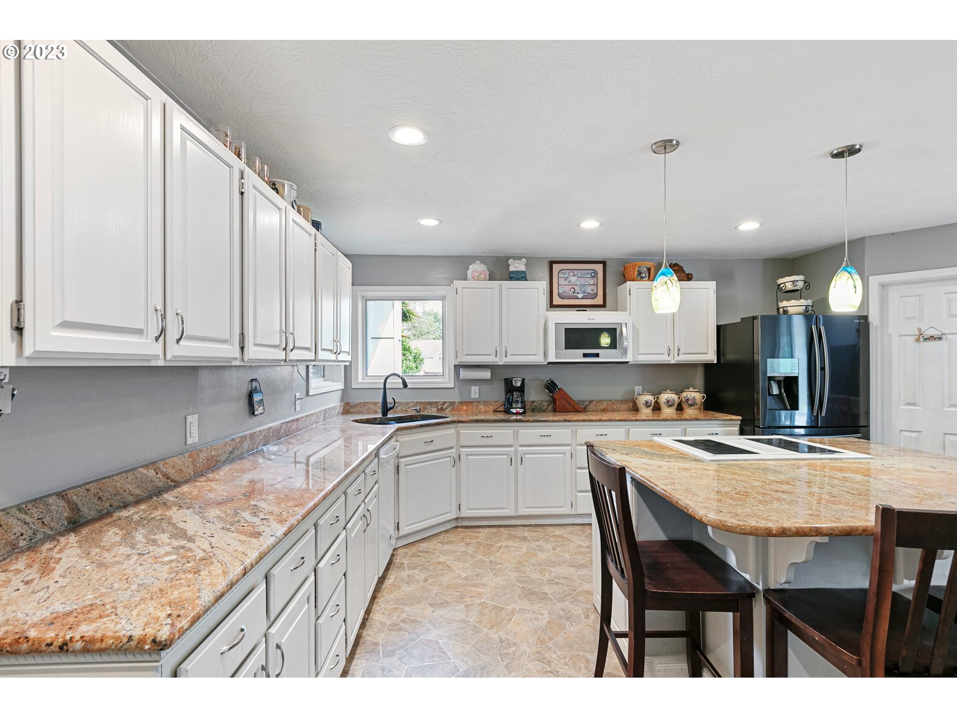 184 73rd Place Springfield, OR 97478 - Photo 7 of 48 a kitchen with stainless steel appliances granite countertop a table chairs sink and cabinets