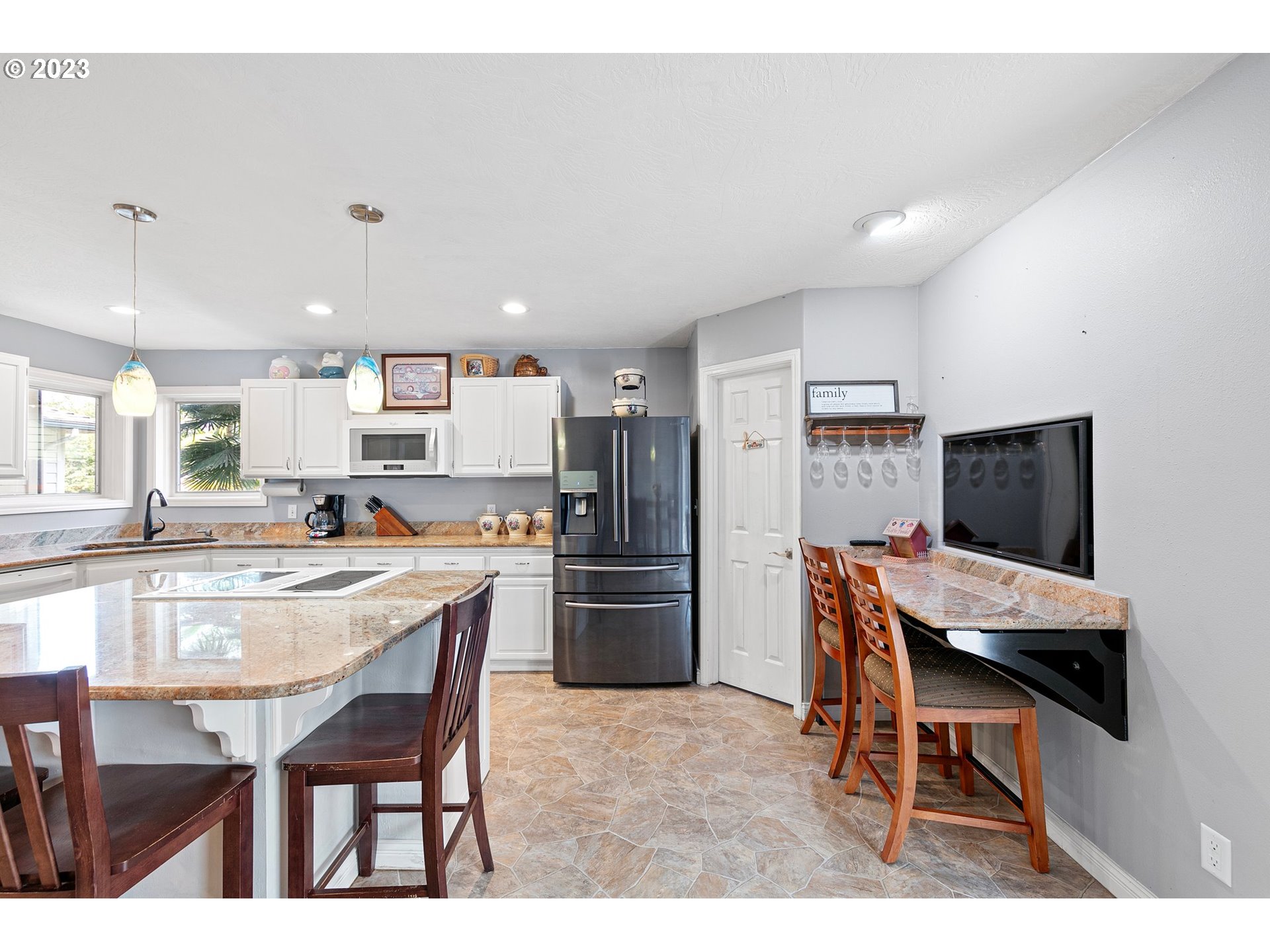184 73rd Place Springfield, OR 97478 - Photo 9 of 48 a kitchen with refrigerator and chairs