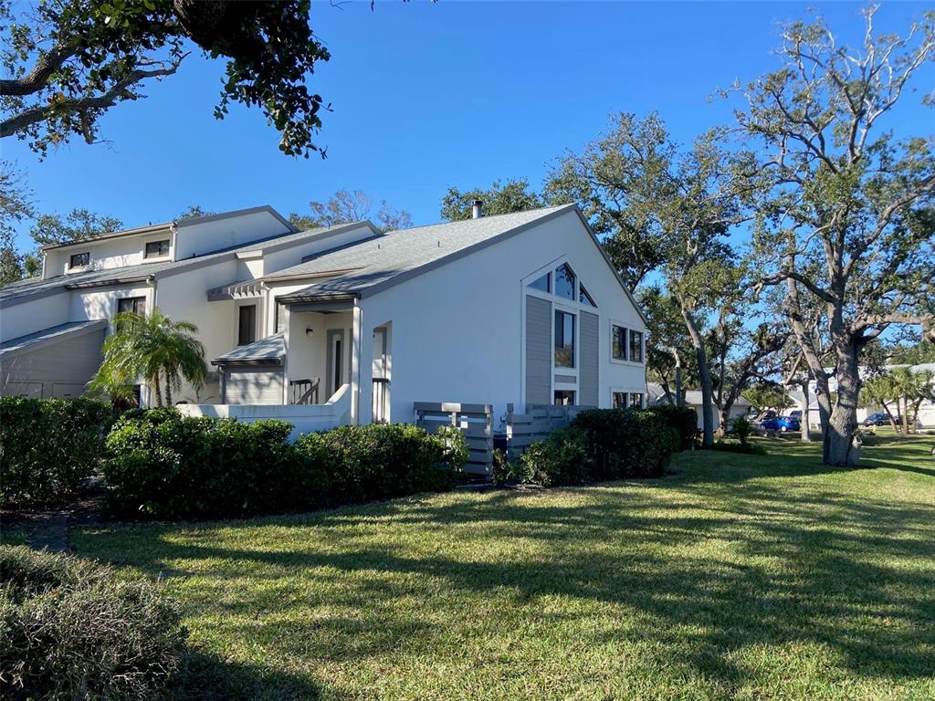 11450 Harbor Way, Unit 5002 Largo, FL 33774 - Photo 1 of 25 a front view of a house with a garden