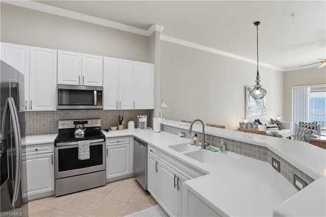 a kitchen with a sink stove and microwave